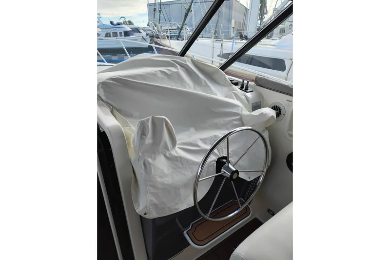 Slide: The Image of 1997 Tiara 3700 Open boat helm with protective cover and steering wheel. - 18