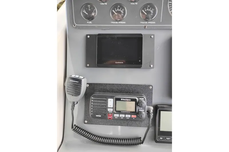 Slide: The Image of 1997 Tiara 3700 Open dashboard with Garmin display and marine radio equipment. - 24