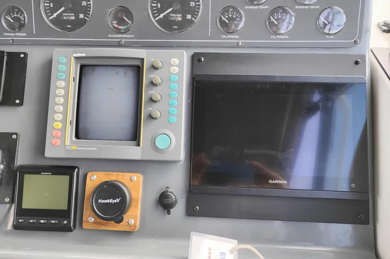 Slide: The Image of Dashboard of a 1997 Tiara 3700 Open with navigation and monitoring equipment. - 25