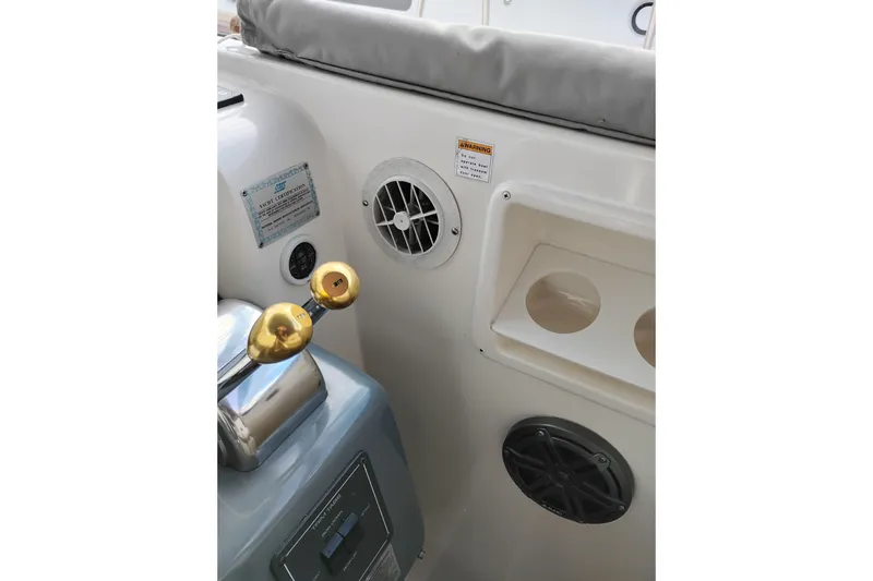 Slide: The Image of 1997 Tiara 3700 Open yacht cockpit controls with gold levers and ventilation. - 27