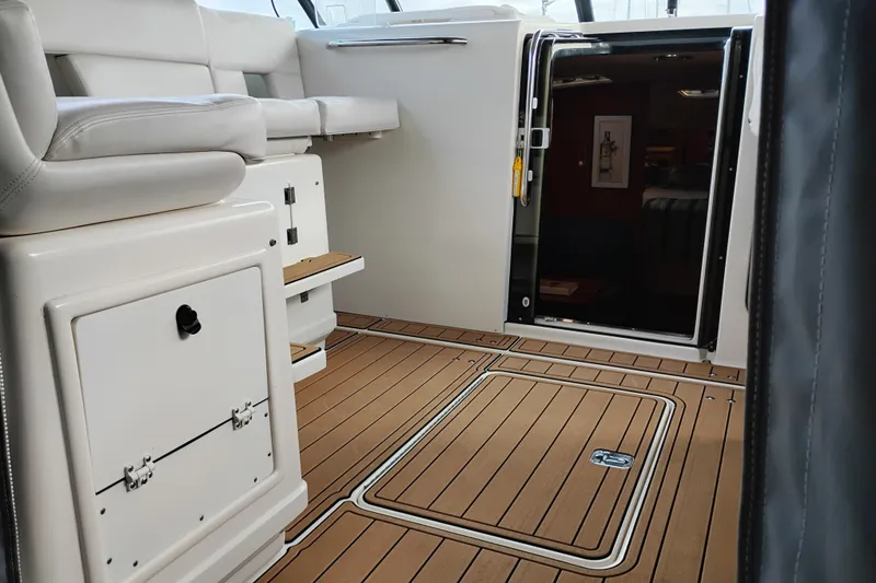 Slide: The Image of Interior of 1997 Tiara 3700 Open yacht with teak flooring and white seating. - 28