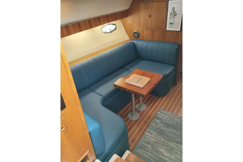 Slide: The Image of 1997 Tiara 3700 Open yacht interior with blue seating and wooden table. - 30