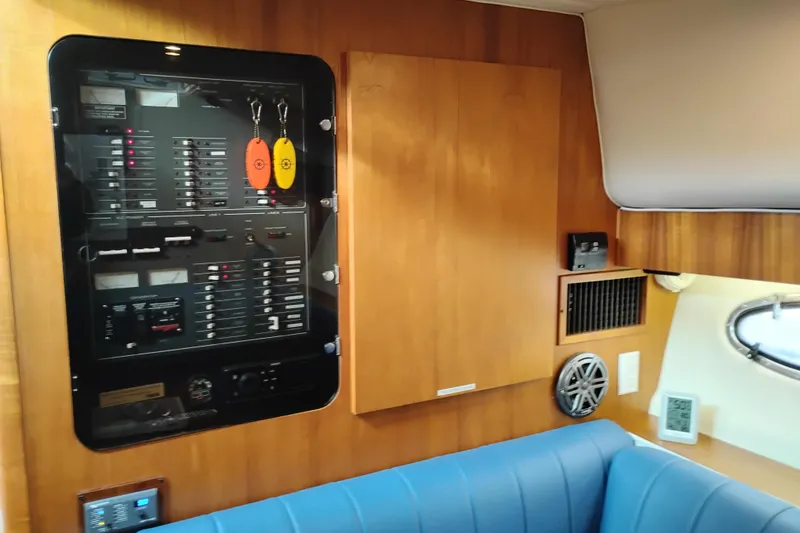 Slide: The Image of 1997 Tiara 3700 Open yacht interior with control panel and blue seating. - 33