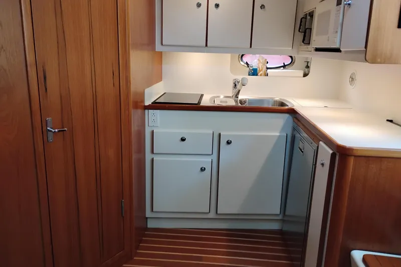 Slide: The Image of 1997 Tiara 3700 Open yacht kitchen with wooden cabinets and modern appliances. - 37