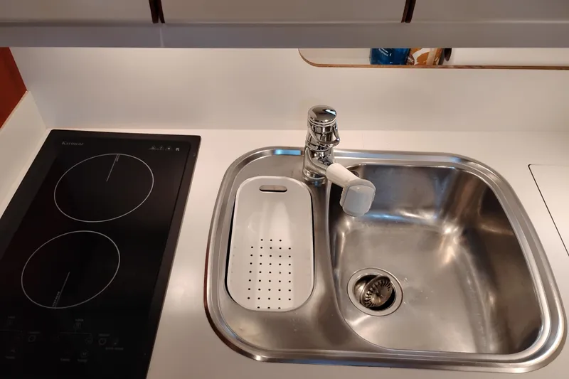 Slide: The Image of Modern kitchen sink and stovetop in 1997 Tiara 3700 Open yacht. - 39