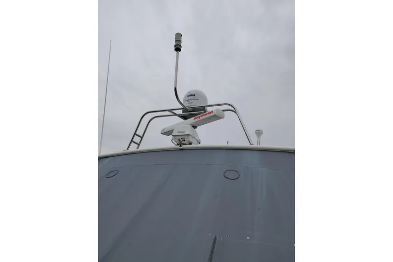 Slide: The Image of 1997 Tiara 3700 Open boat radar and antenna equipment against cloudy sky. - 4