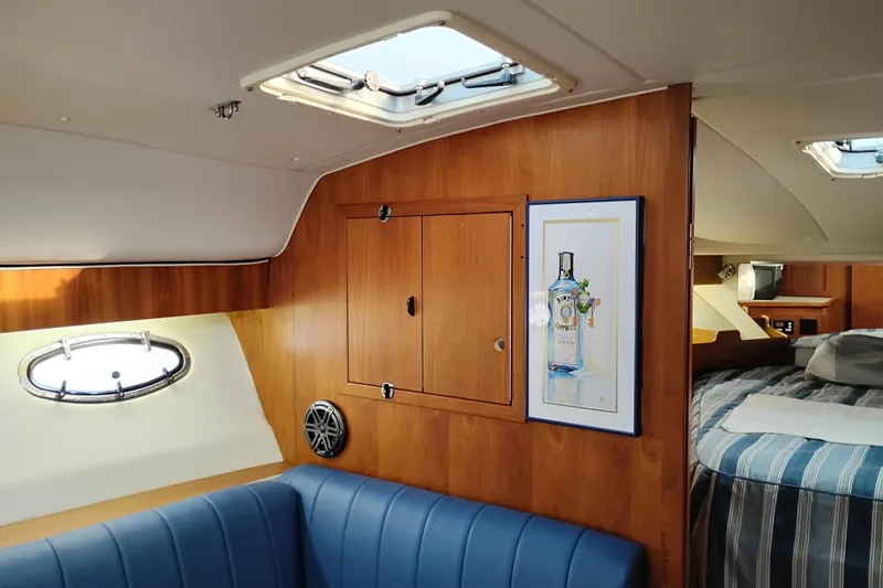 Slide: The Image of Interior of 1997 Tiara 3700 Open yacht with wood paneling and blue seating. - 42