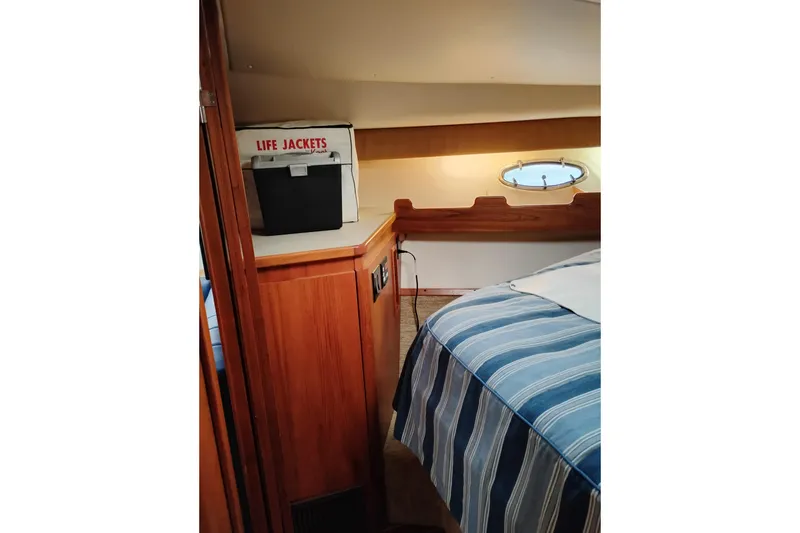 Slide: The Image of Interior of 1997 Tiara 3700 Open boat with life jackets and striped bedding. - 46