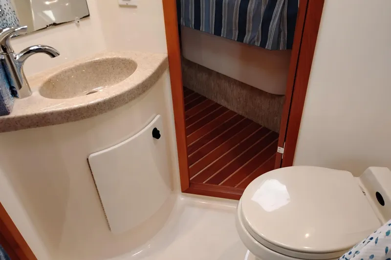 Slide: The Image of Bathroom interior of 1997 Tiara 3700 Open yacht with sink and toilet. - 49