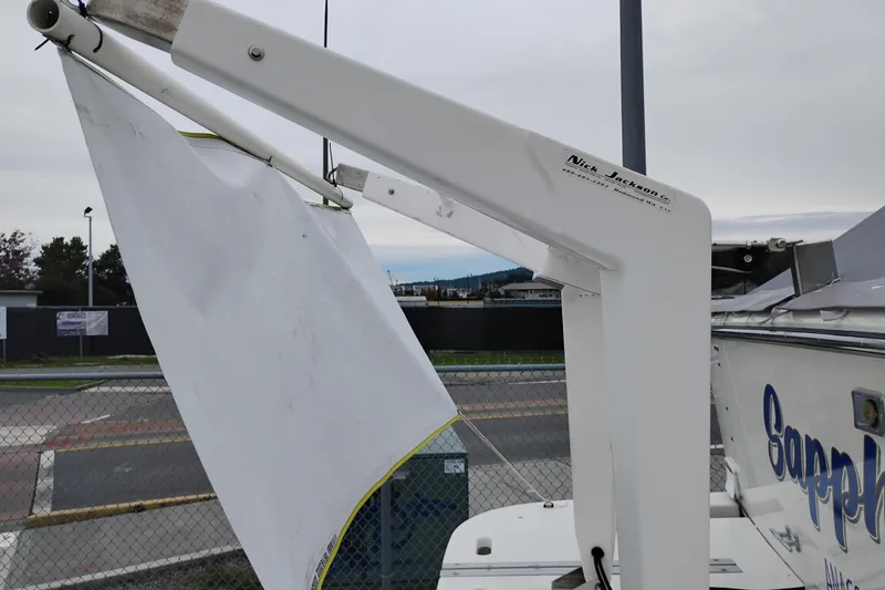 Slide: The Image of 1997 Tiara 3700 Open boat with Nick Jackson Co. davit system, docked near a fence. - 5