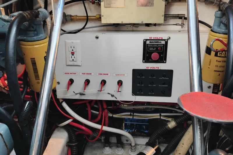 Slide: The Image of Electrical panel of a 1997 Tiara 3700 Open boat, featuring switches and wiring. - 56