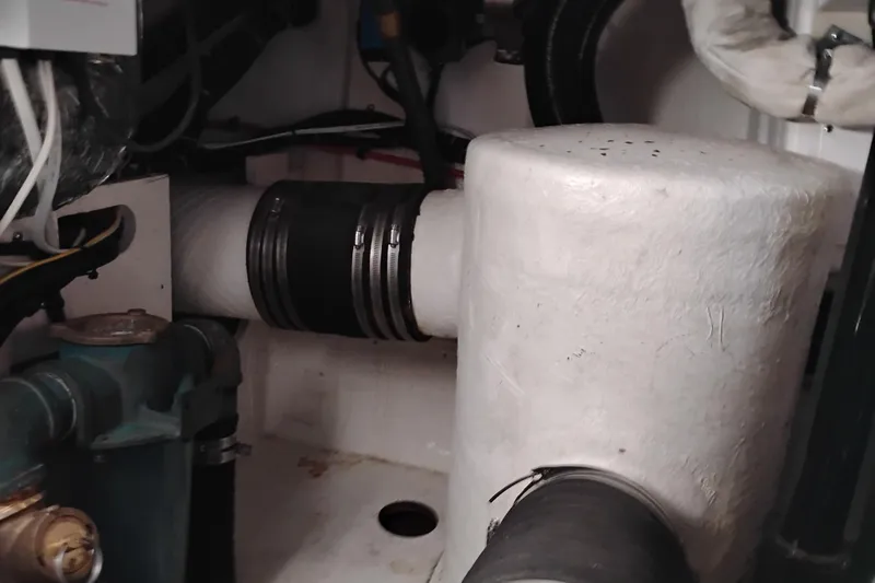Slide: The Image of Engine compartment of a 1997 Tiara 3700 Open boat, showing pipes and components. - 58