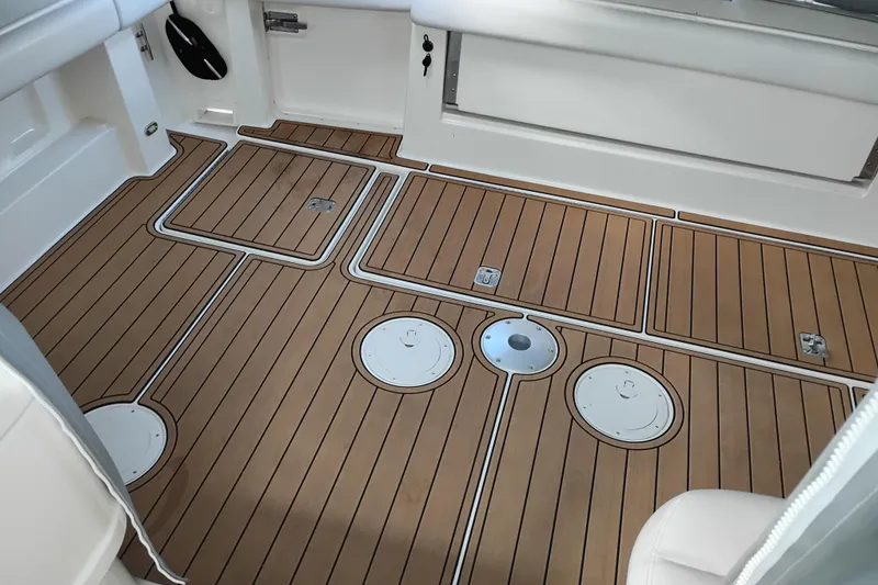 Slide: The Image of 1997 Tiara 3700 Open boat deck with teak flooring and storage hatches. - 6