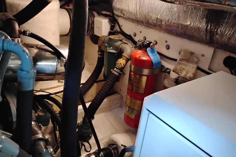 Slide: The Image of Engine room of 1997 Tiara 3700 Open with fire extinguisher and mechanical components. - 61