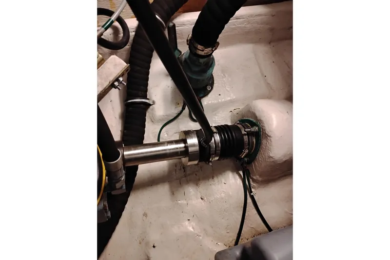 Slide: The Image of Engine compartment of a 1997 Tiara 3700 Open boat, showing mechanical components and hoses. - 62