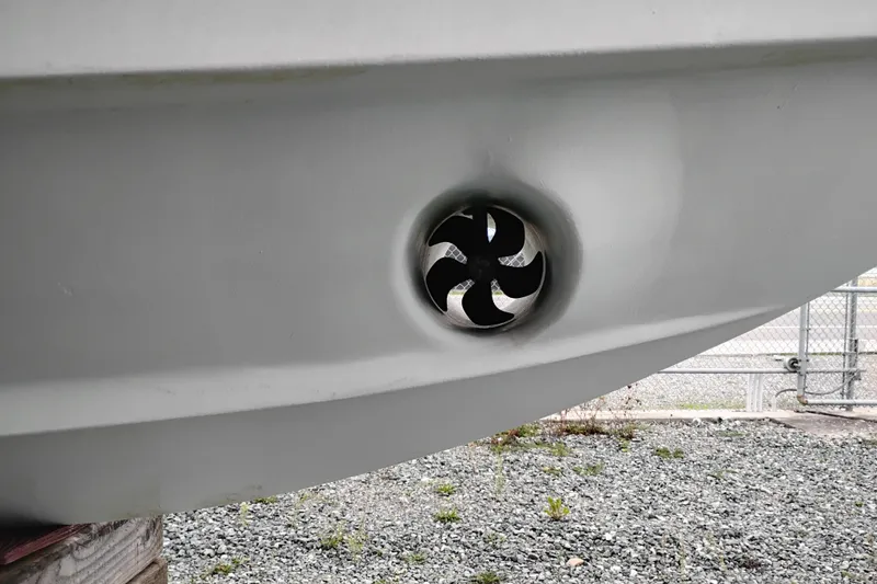 Slide: The Image of Close-up of a 1997 Tiara 3700 Open boat's bow thruster on gravel surface. - 63