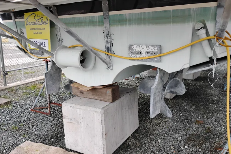 Slide: The Image of 1997 Tiara 3700 Open boat on blocks, propeller visible, for sale sign attached. - 64