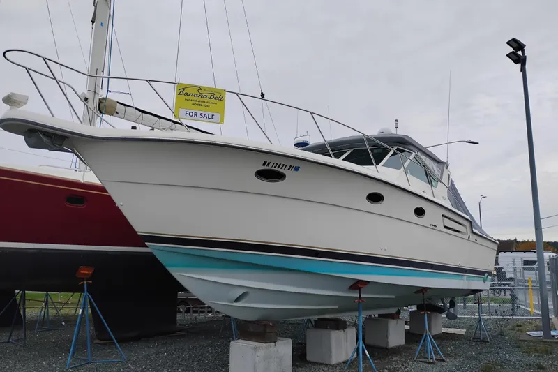 Slide: The Image of 1997 Tiara 3700 Open boat for sale, displayed on stands in a marina. - 65