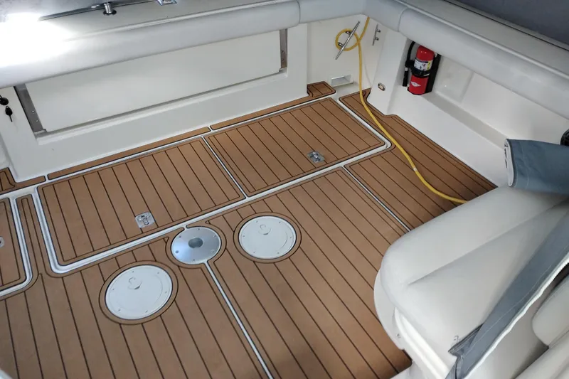 Slide: The Image of 1997 Tiara 3700 Open boat interior with teak flooring and seating area. - 9