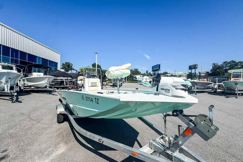 Slide: The Image of 2023 G3 Bay 17 boat on trailer in dealership lot under clear blue sky. - 3