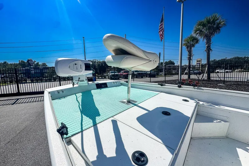 Slide: The Image of 2023 G3 Bay 17 boat deck with seat, motor, and American flag in background. - 6