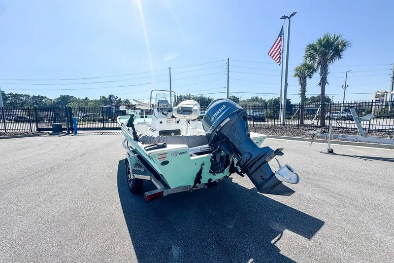 Slide: The Image of 2023 G3 Bay 17 boat with Yamaha motor, parked outdoors under clear blue sky. - 8