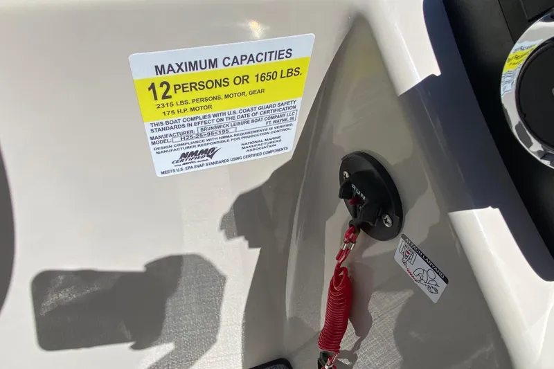 Slide: The Image of 2023 Harris Cruiser 250 capacity label, 12 persons or 1650 lbs, safety compliance details. - 7