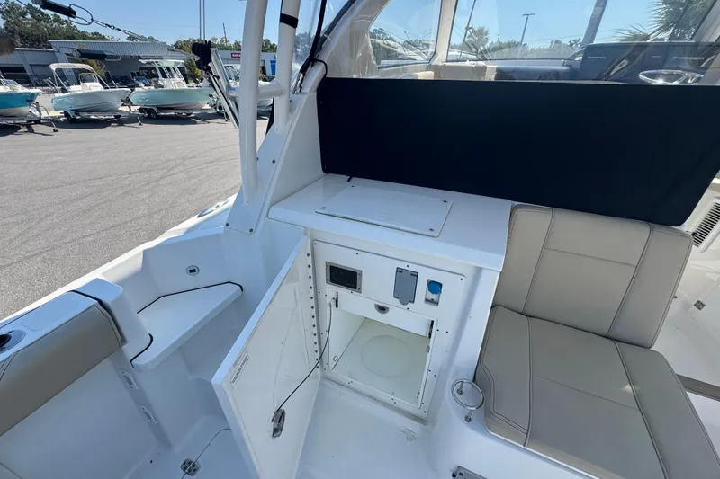 Slide: The Image of 2020 Pursuit OS 325 Offshore boat interior with seating and storage compartments. - 5