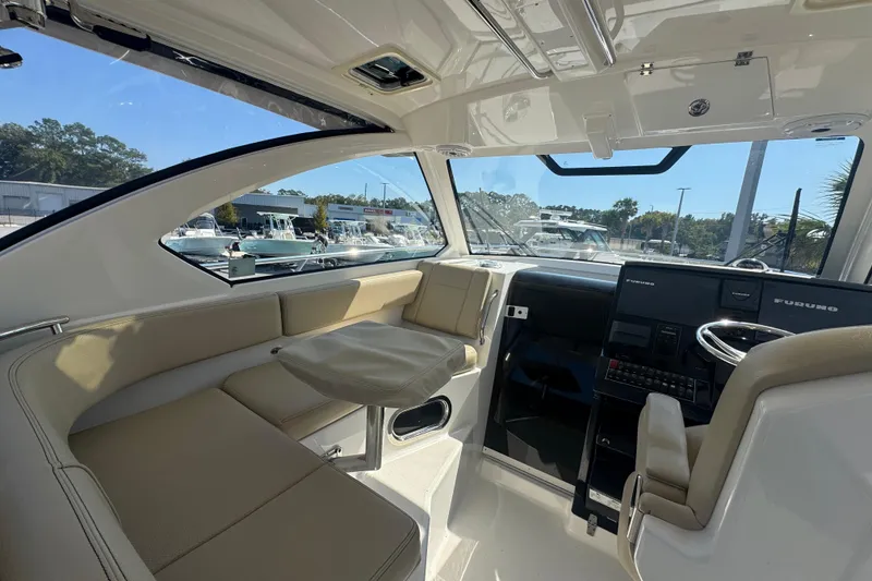 Slide: The Image of Interior of 2020 Pursuit OS 325 Offshore boat with seating and navigation equipment. - 6