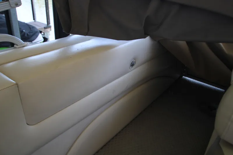 Slide: The Image of 2005 Bennington 2275FSi boat interior with beige seating and covered area. - 16