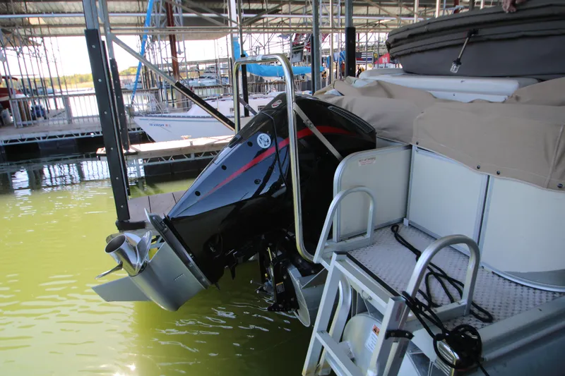 Slide: The Image of Covered 2005 Bennington 2275FSi boat docked in a marina. - 7
