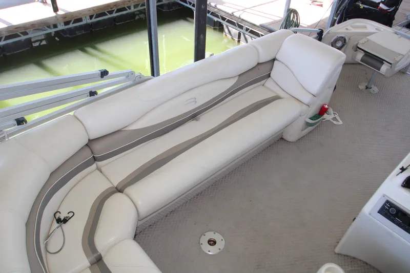 Slide: The Image of 2005 Bennington 2275FSi boat with outboard motor docked in marina. - 8