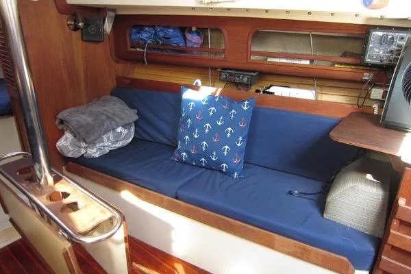 Slide: The Image of Cozy interior of 1988 CAL 28 sailboat with blue cushions and nautical decor. - 25