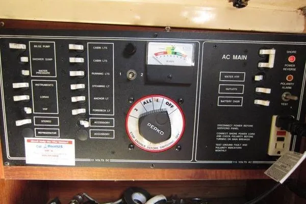 Slide: The Image of Electrical control panel of a 1988 CAL 28 boat, featuring switches and gauges. - 30