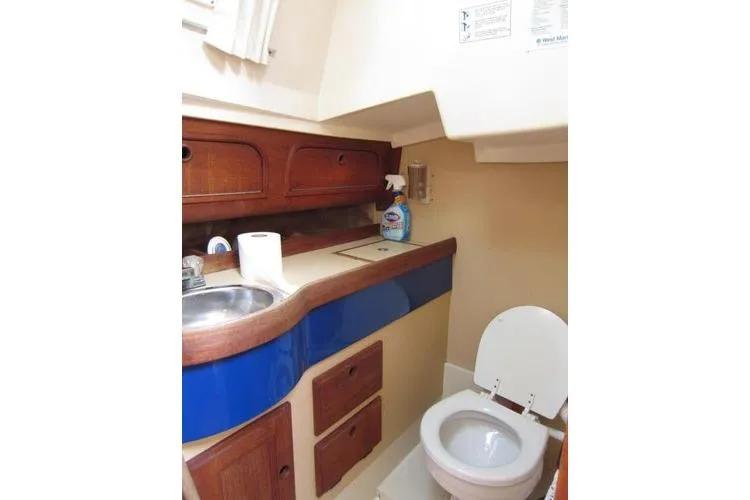 Slide: The Image of Compact boat bathroom with sink, toilet, and storage in a 1988 CAL 28 model. - 36