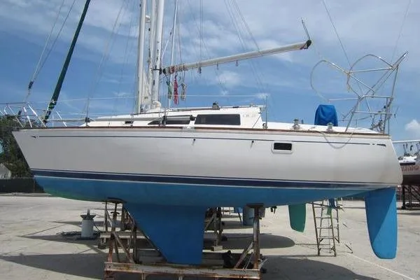 Slide: The Image of 1988 CAL 28 sailboat on dry dock, white hull with blue keel and rudder. - 4