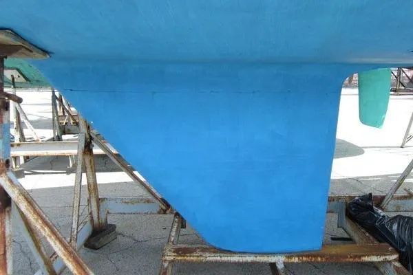 Slide: The Image of Blue hull of a 1988 CAL 28 sailboat on a stand. - 6