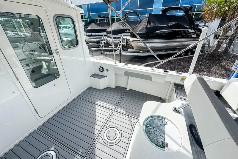 Slide: The Image of 2023 Parker 2120 Sport Cabin boat interior with seating and modern design. - 7