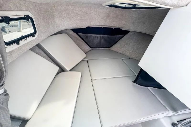 Slide: The Image of 2023 Parker 2120 Sport Cabin interior with cushioned seating and windows. - 8