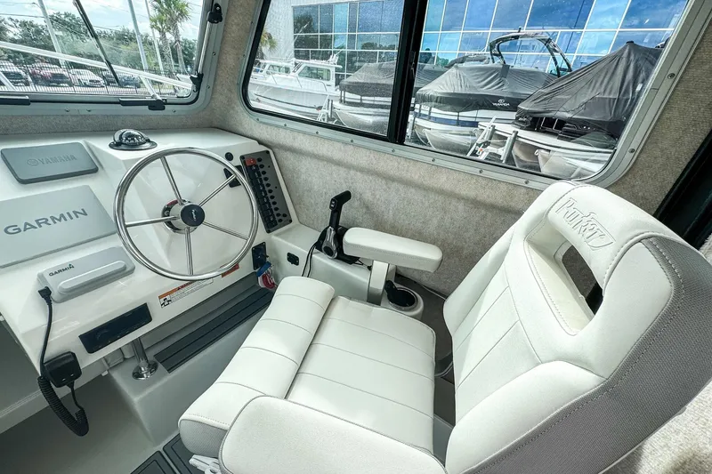 Slide: The Image of 2023 Parker 2120 Sport Cabin interior with Garmin navigation and comfortable seating. - 9