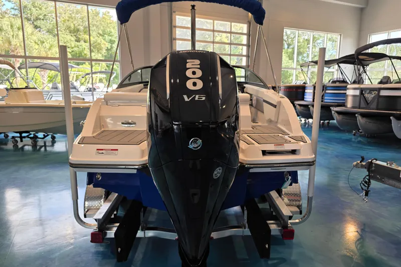 Slide: The Image of 2024 Monterey M-205 boat with 200 V6 engine in showroom setting. - 4