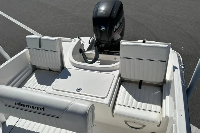 Slide: The Image of 2019 Bayliner Element F18 boat interior with seating and Mercury outboard motor. - 12