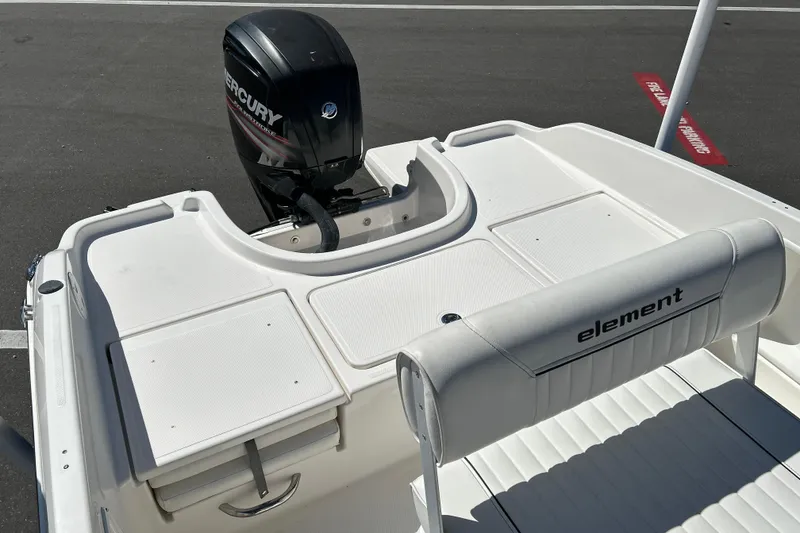 Slide: The Image of 2019 Bayliner Element F18 boat with Mercury outboard motor, white seating, and storage compartments. - 13