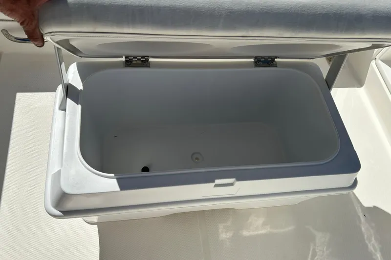 Slide: The Image of Open storage compartment on 2019 Bayliner Element F18 boat. - 17