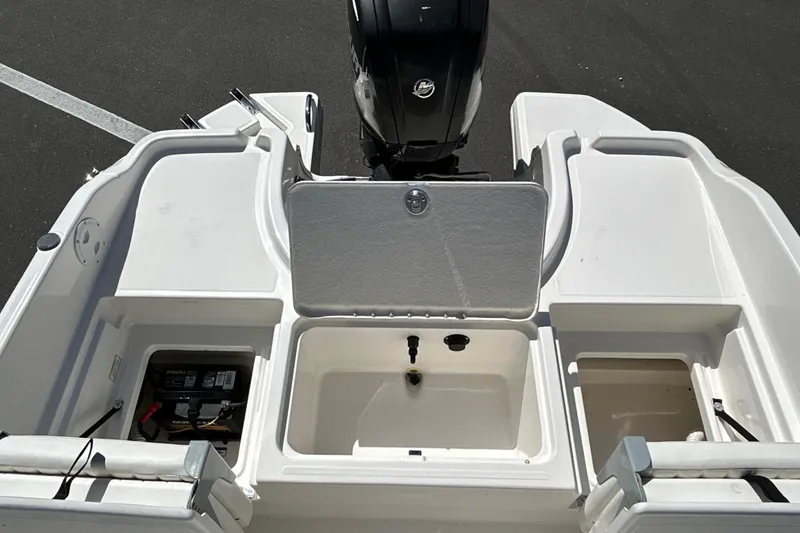 Slide: The Image of 2019 Bayliner Element F18 boat stern with open storage compartments and outboard motor. - 18