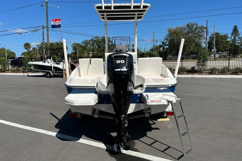 Slide: The Image of 2019 Bayliner Element F18 boat with 90 HP engine, parked outdoors. - 3