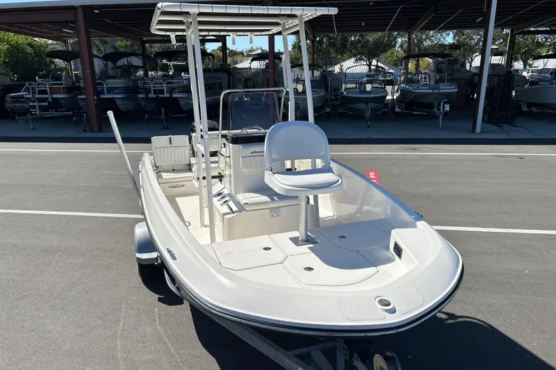 Slide: The Image of 2019 Bayliner Element F18 boat on trailer in marina parking lot. - 6