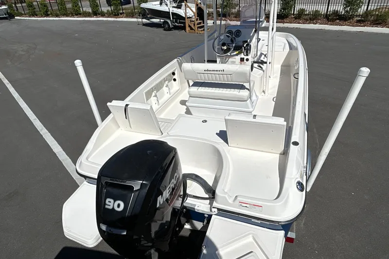 Slide: The Image of 2019 Bayliner Element F18 boat with Mercury 90 engine, parked on pavement. - 7