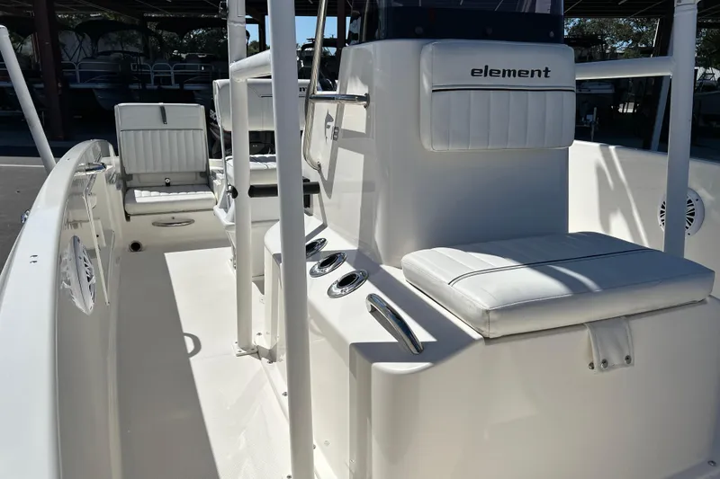 Slide: The Image of 2019 Bayliner Element F18 boat interior with white seating and console. - 9