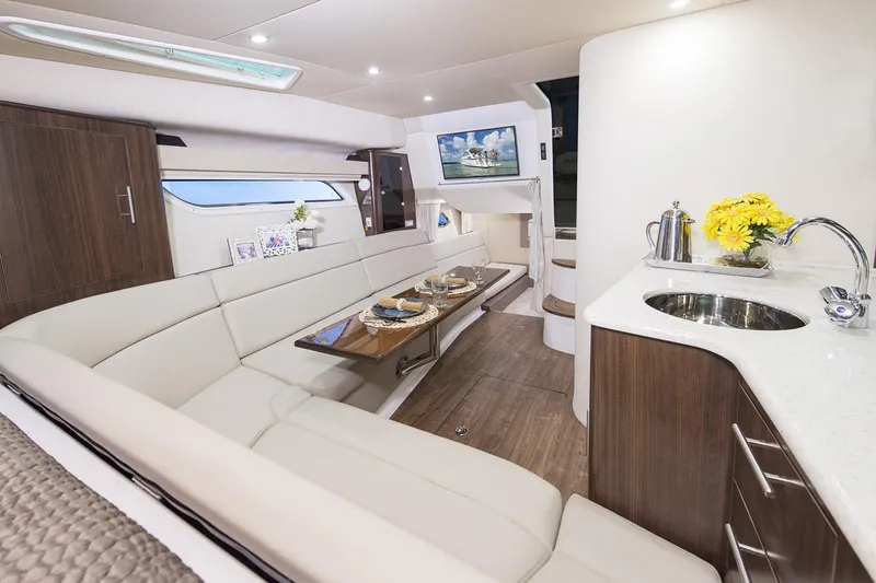 Slide: The Image of Manufacturer Provided Image: Interior of 2017 Regal 35 Sport Coupe yacht with modern seating, dining area, and kitchenette. - 11